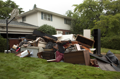 House with broken funiture piled in the yard