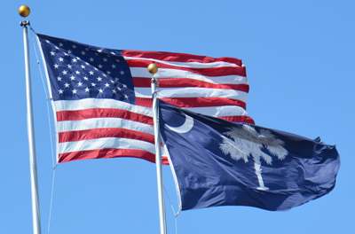 American flag and SC flag waving in wind